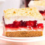 A slice of cherry yum on a round plate.
