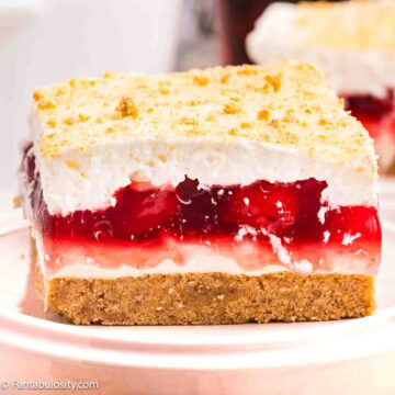 A slice of cherry yum on a round plate.