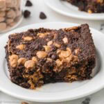 A slice of chocolate peanut butter dump cake on a round plate.