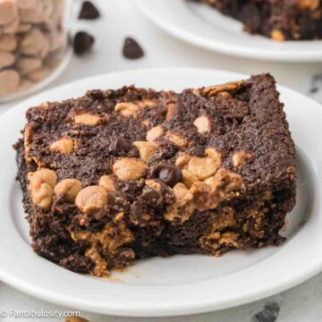 A slice of chocolate peanut butter dump cake on a round plate.
