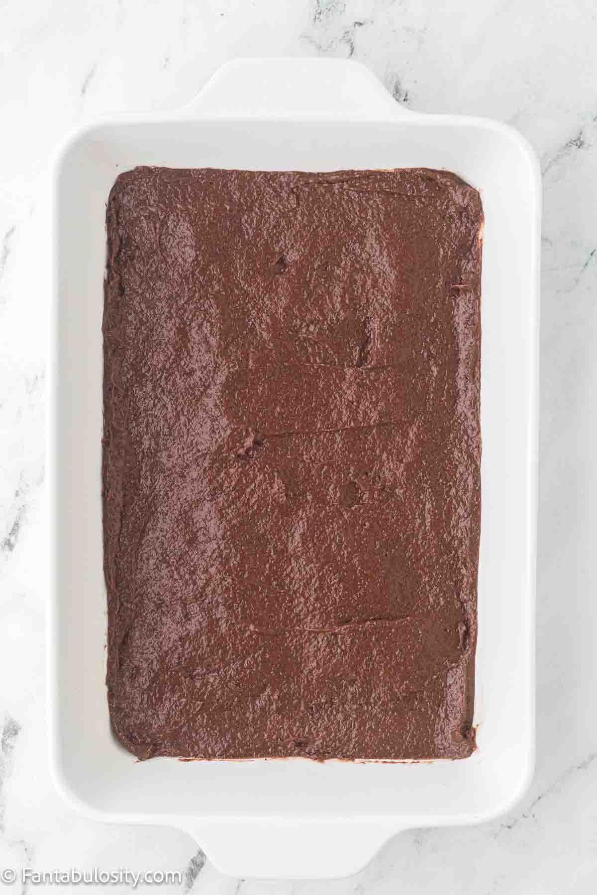 Chocolate pudding poured in to 9x13 baking pan for dump cake.