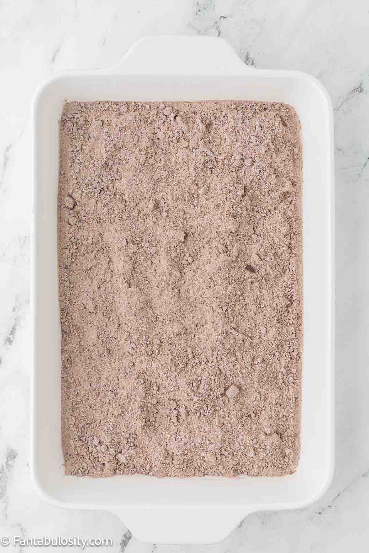 Chocolate cake mix sprinkled on top of peanut butter layer.