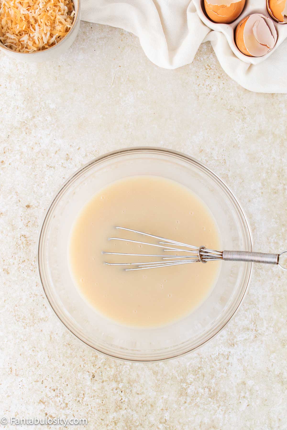 Cream of coconut, and sweetened condensed milk in mixing bowl.