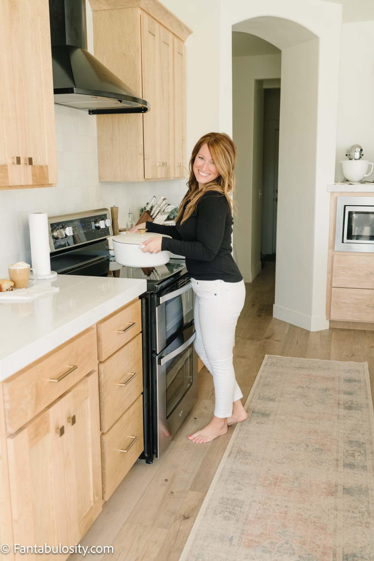 Jessica Burgess standing in the kitchen, cooking at the stove.