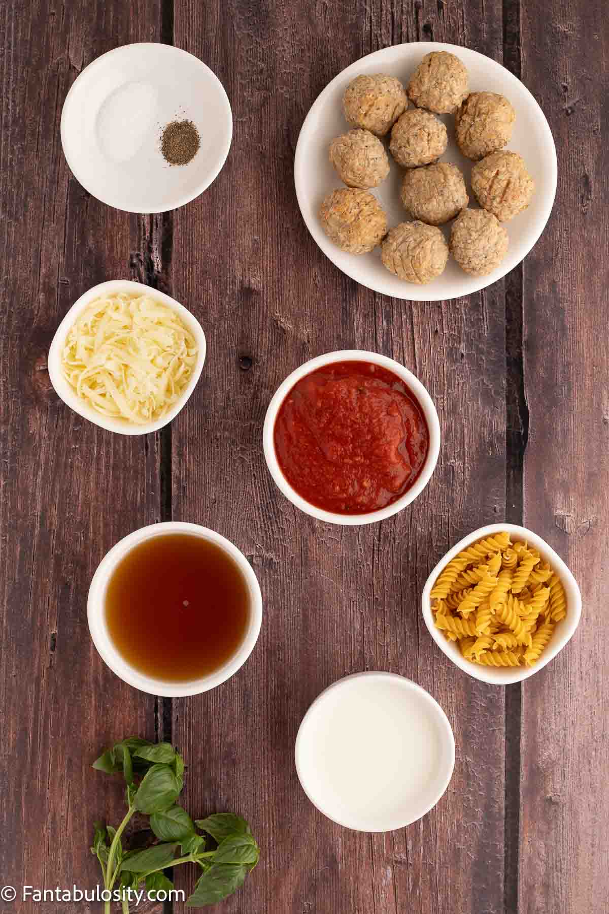 Ingredients for meatball casserole on wooden table.