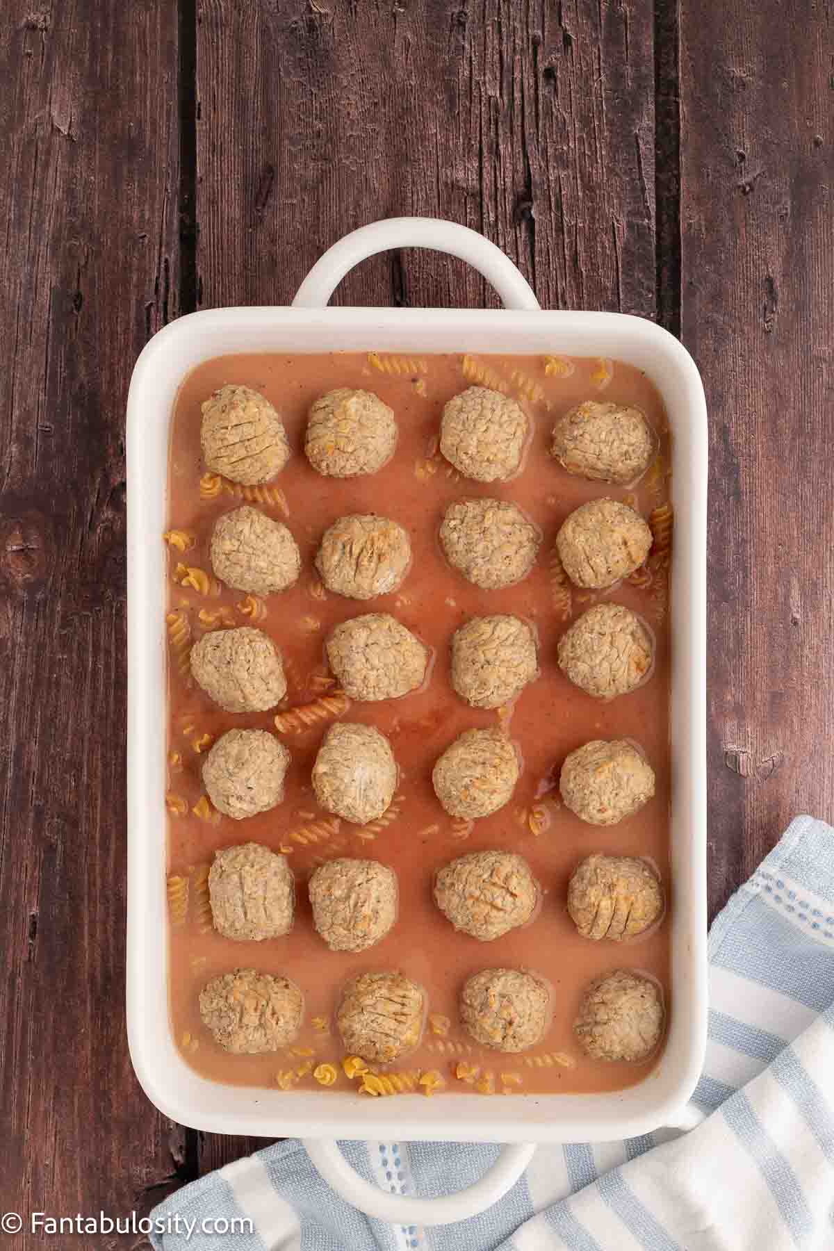 Meatballs placed on top of noodles.