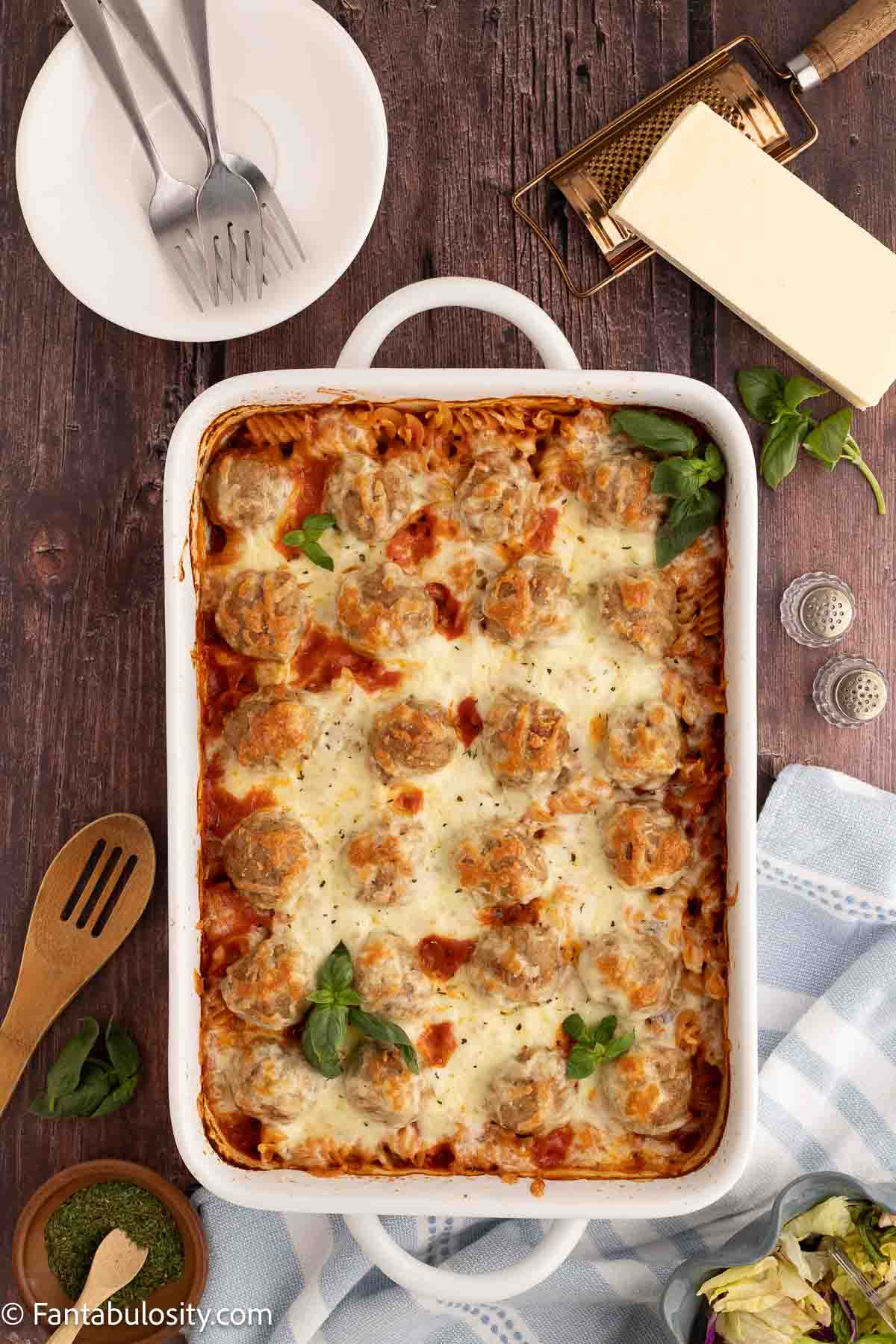 Cheese melted on top of meatball casserole in 9x13 baking dish.