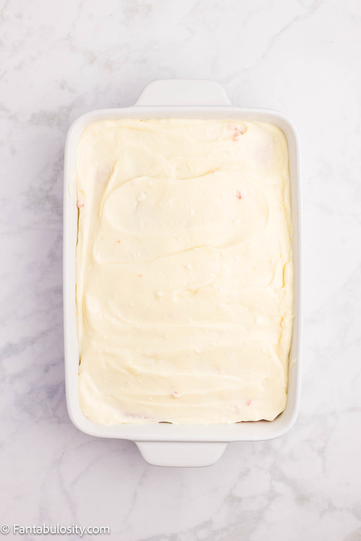 Pudding mixture spread on top of the cake.