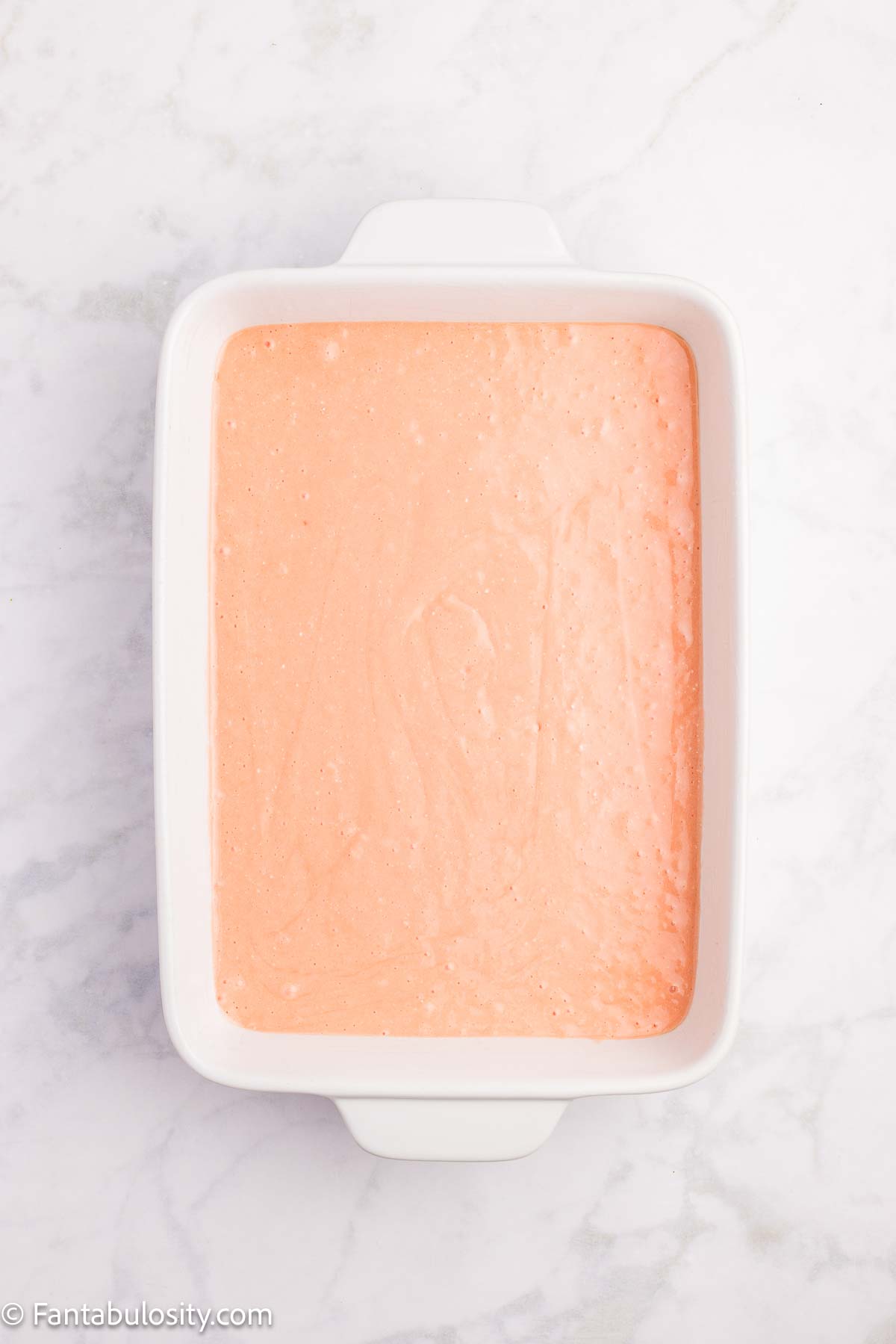 Strawberry cake batter in 9x13 baking pan.