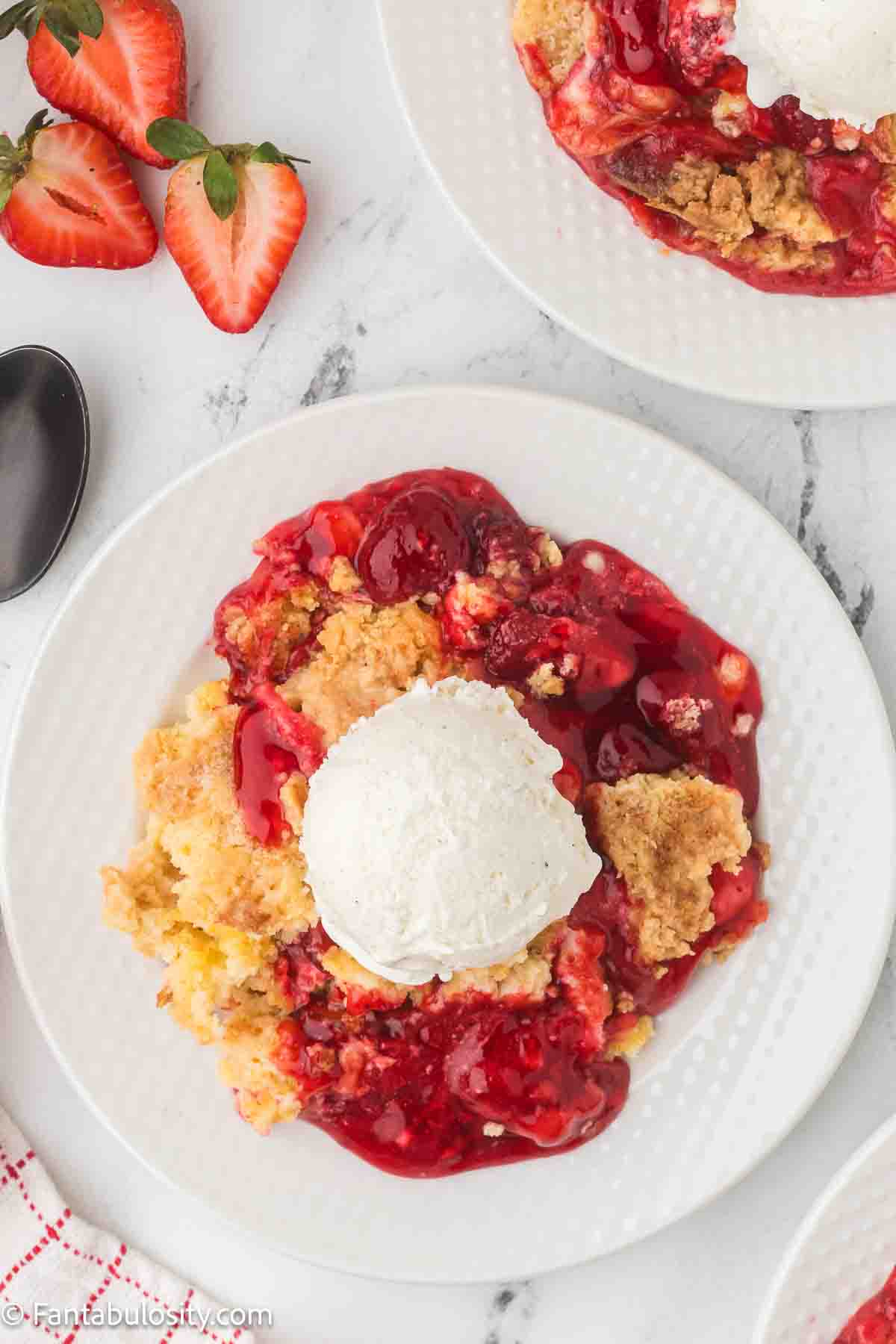 Strawberry Cream Cheese Dump Cake on round plate.