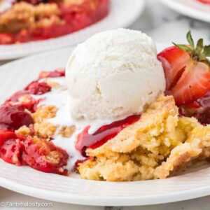 Strawberry Cream Cheese Dump Cake serving on a round plate.
