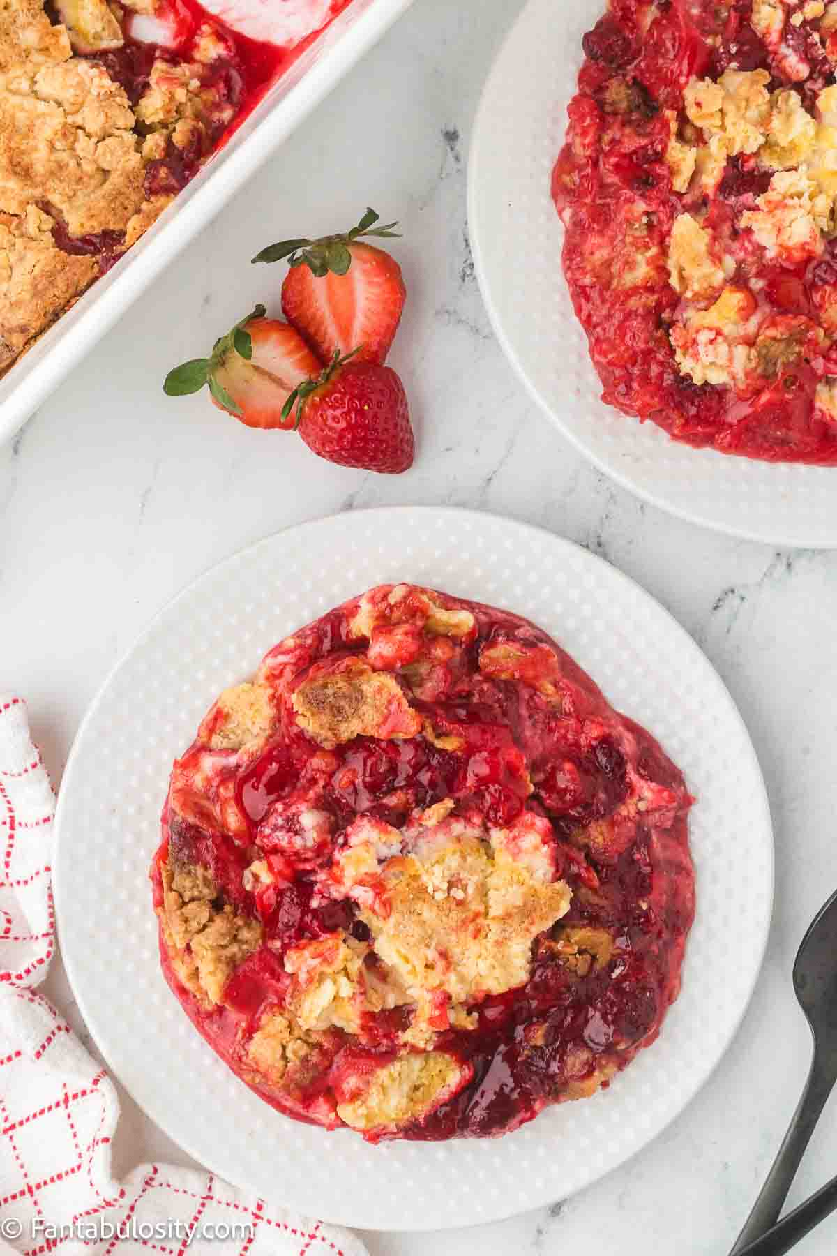 Strawberry Cream Cheese Dump Cake serving on round plate.