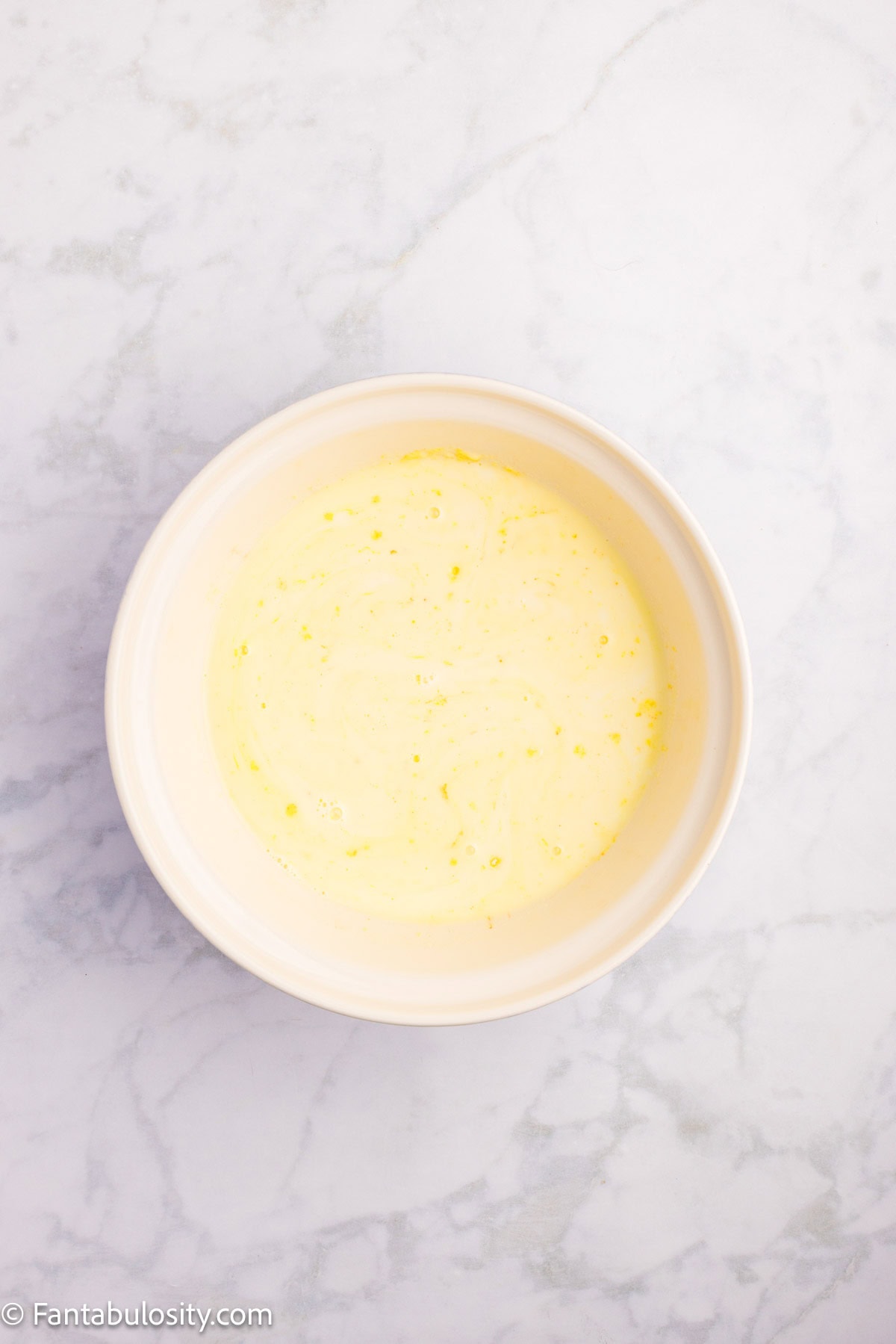 Vanilla pudding mixed in mixing bowl.