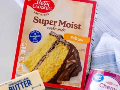 Cake mix, butter and canned fruit on counter for a dump cake recipe.