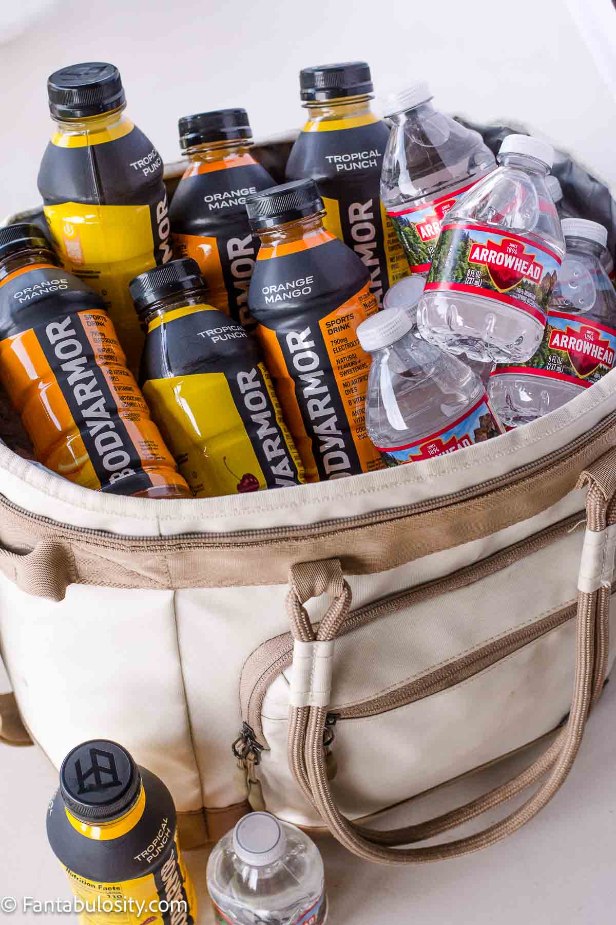 A cooler full of sports drinks and bottled water.
