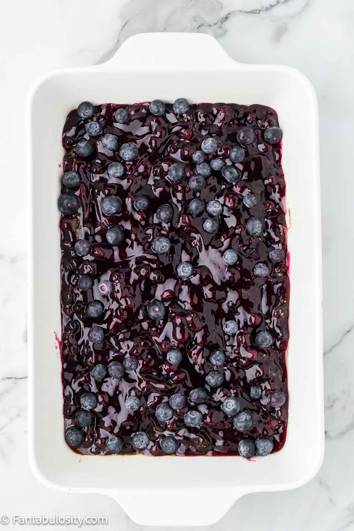 Fresh blueberries sprinkled on top of blueberry pie filling.