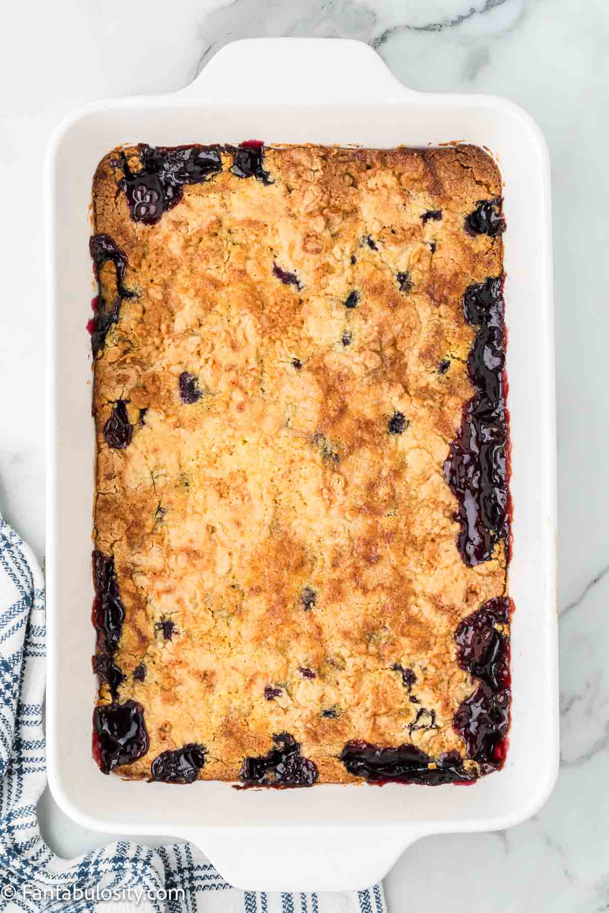 Baked blueberry dump cake in 9x13 baking dish.