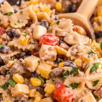 Cowboy Pasta Salad in bowl with wooden spoon.