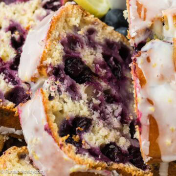 Sliced lemon blueberry bread with lemon glaze.