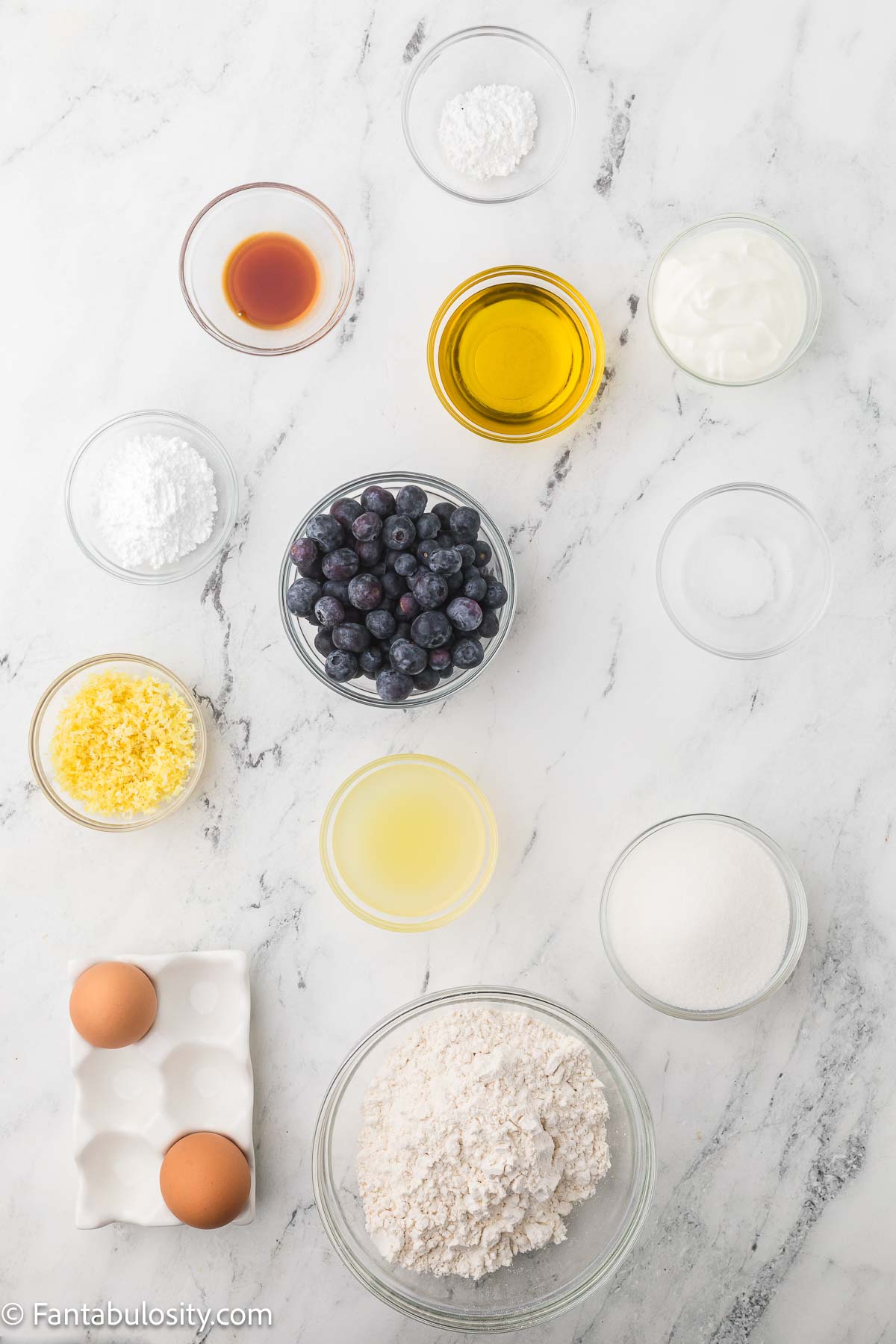 Ingredients to make lemon blueberry bread, sitting on counter.