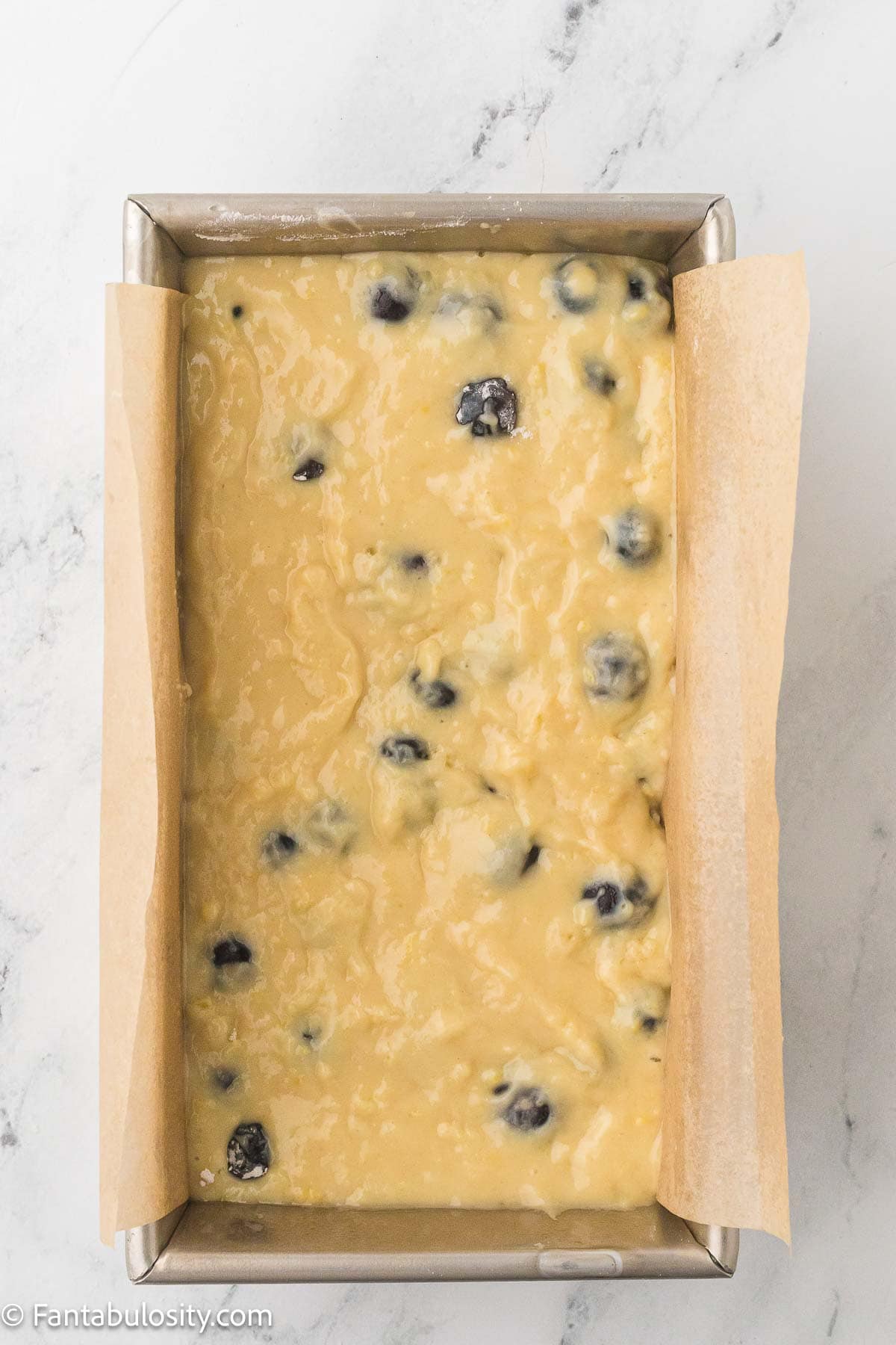 Lemon blueberry bread batter in loaf pan.