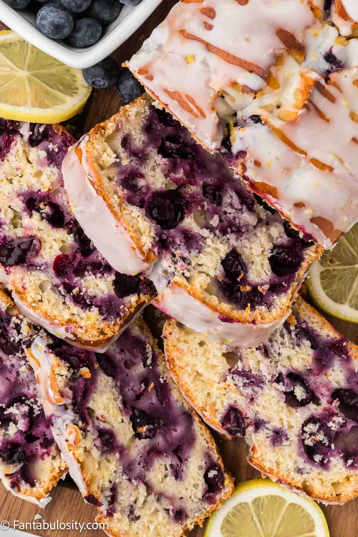 Sliced lemon blueberry bread, with lemon glaze.