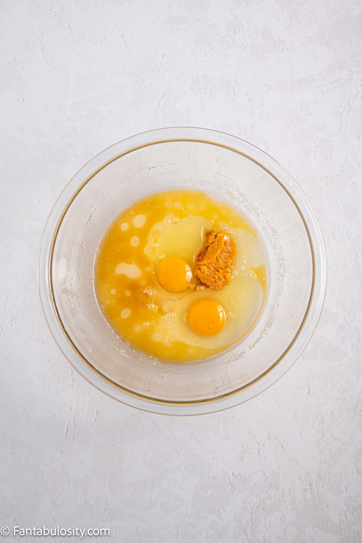 Eggs, sugar, orange juice, orange zest, and oil in mixing bowl.