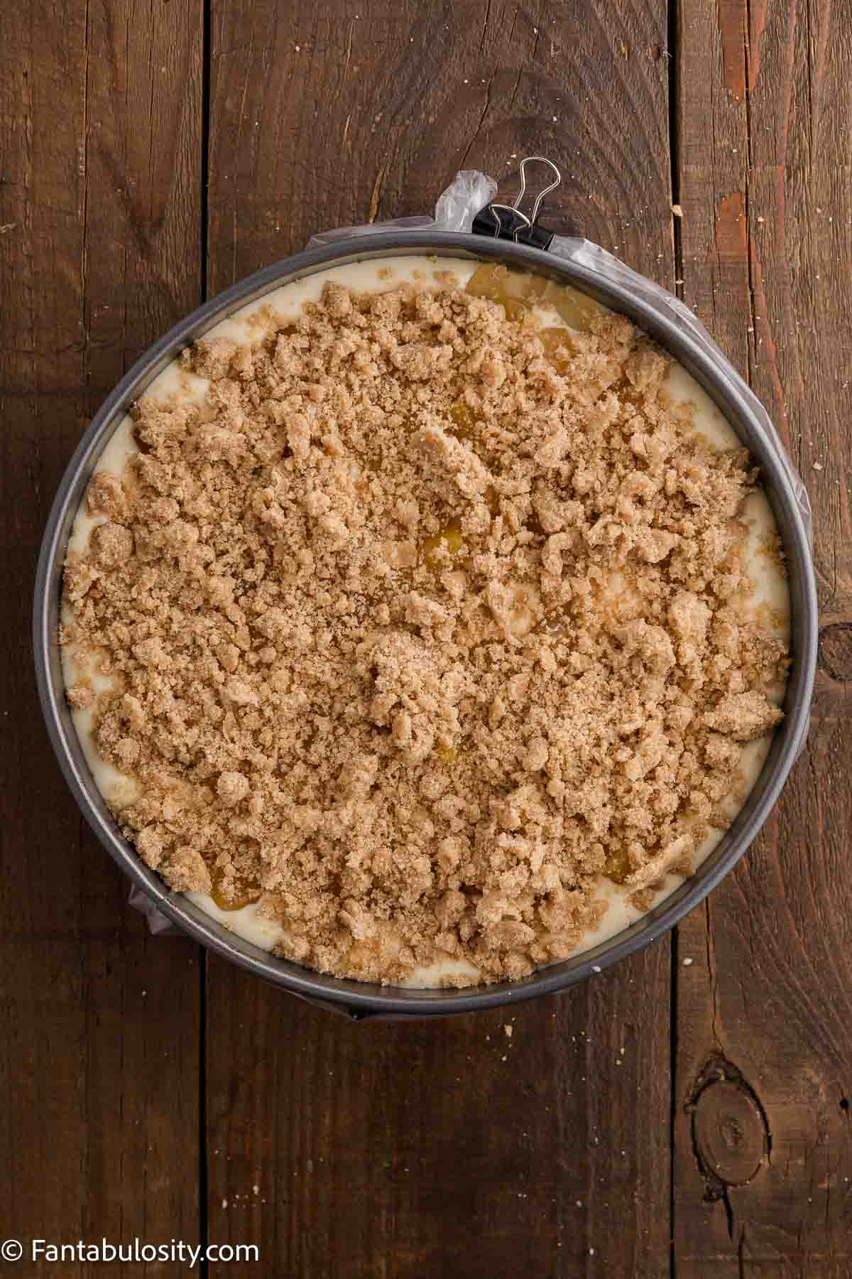 Remaining cheesecake batter poured in to spring pan, topped with peaches and topping.