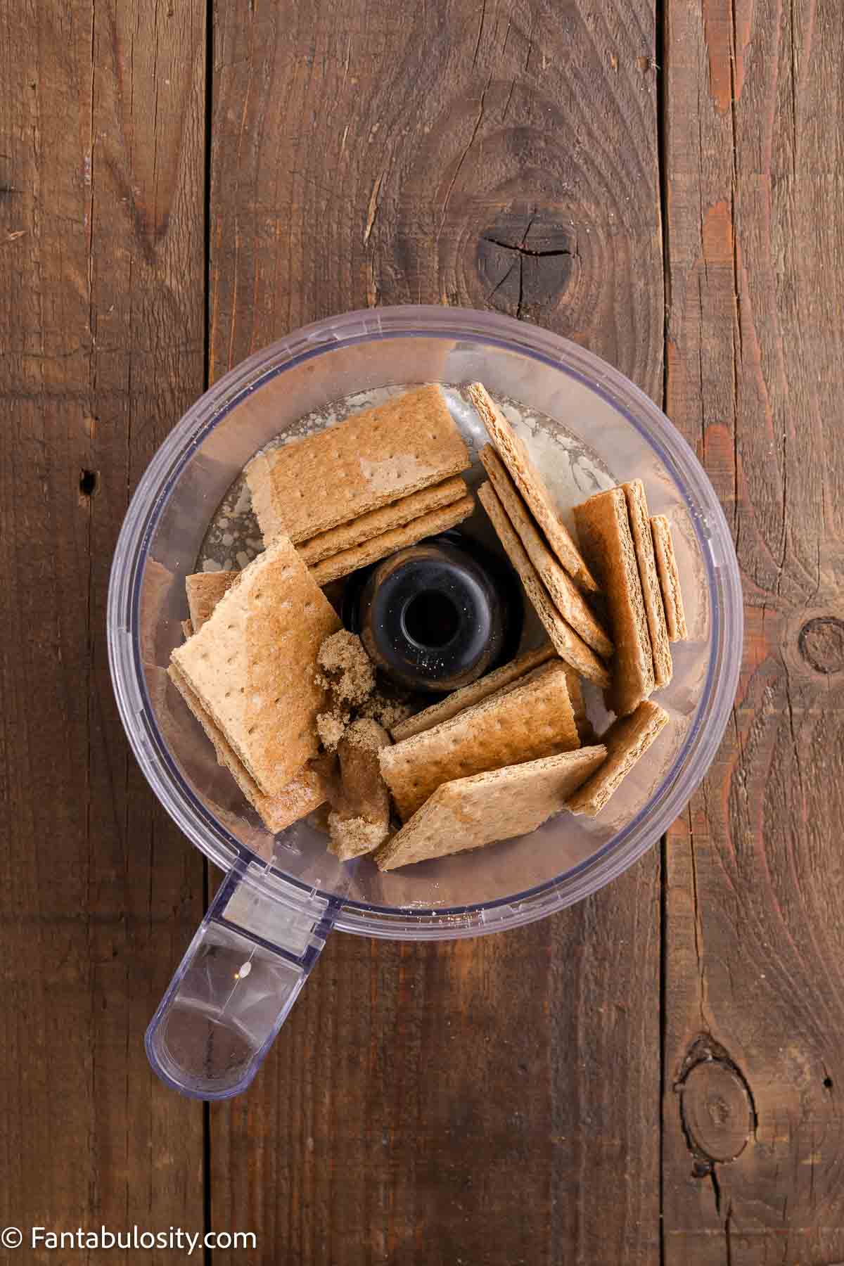 graham cracker crust mixture in food processor for cheesecake