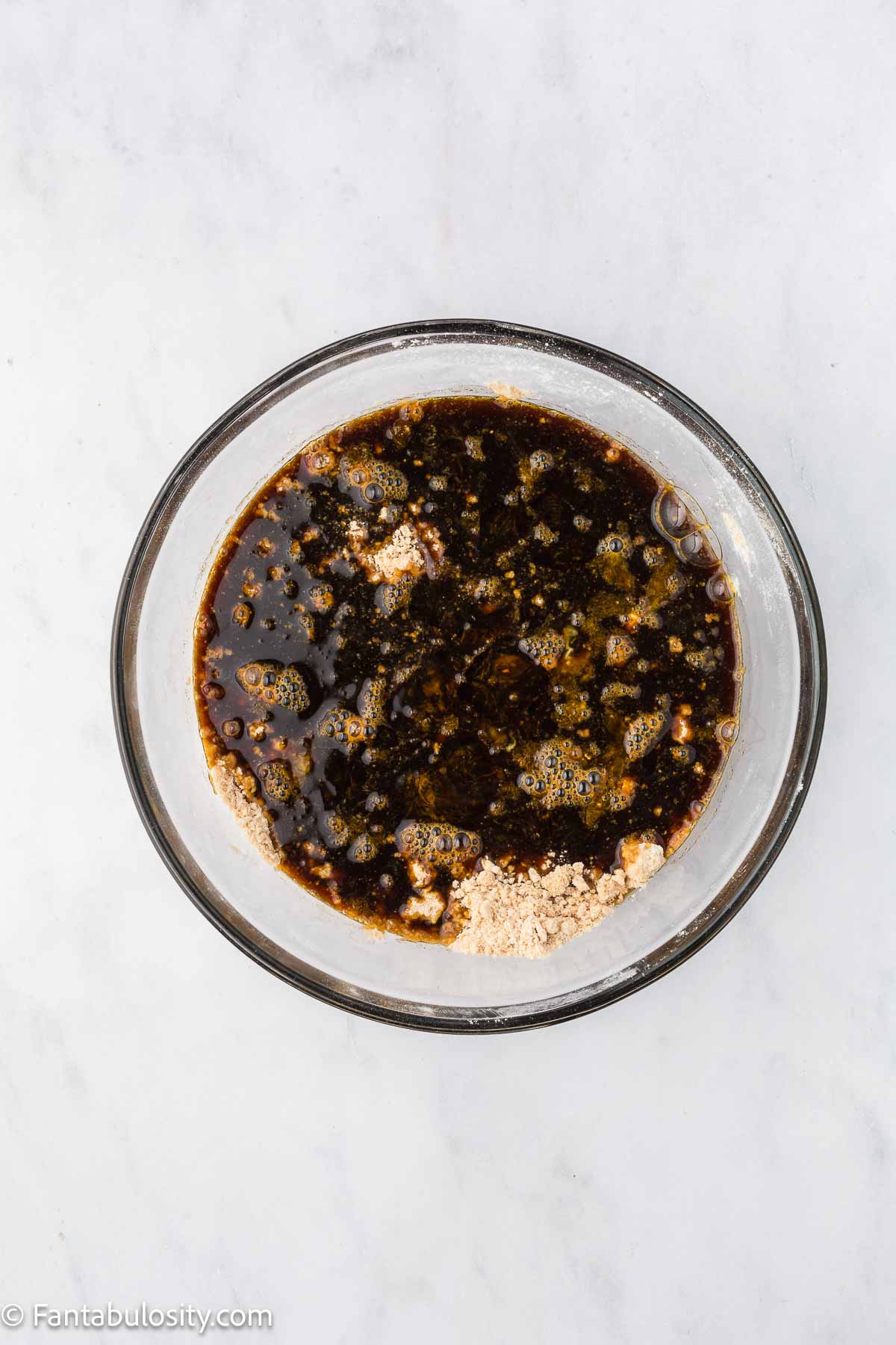Molasses mixture added to dry mixture in mixing bowl.