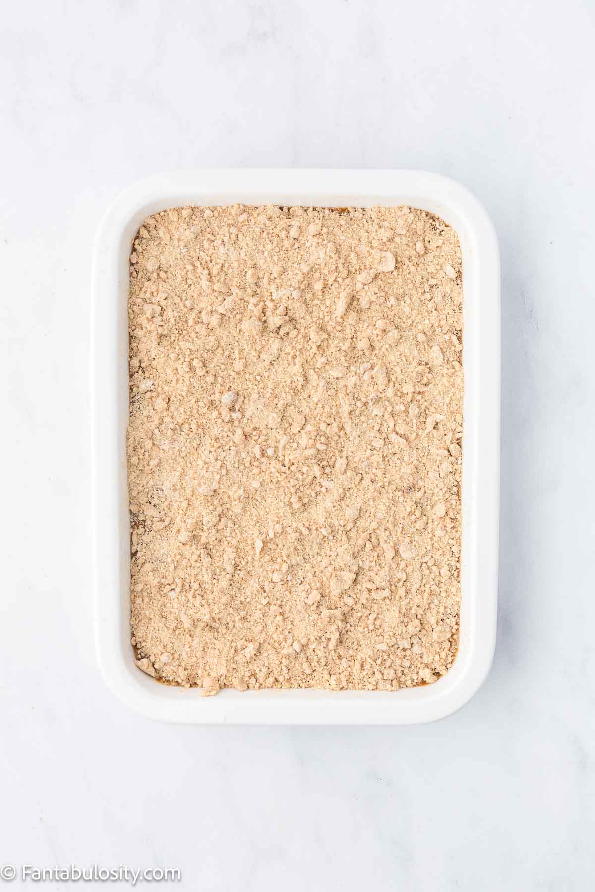 Buttery crumb mixture poured on top of Shoofly cake batter in 9x13 pan.