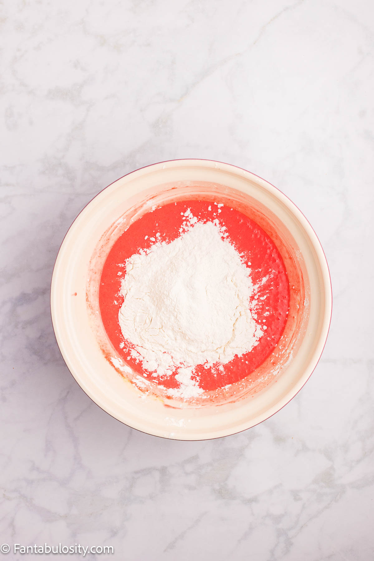 Dry ingredients added to wet, jello batter for strawberry bread.