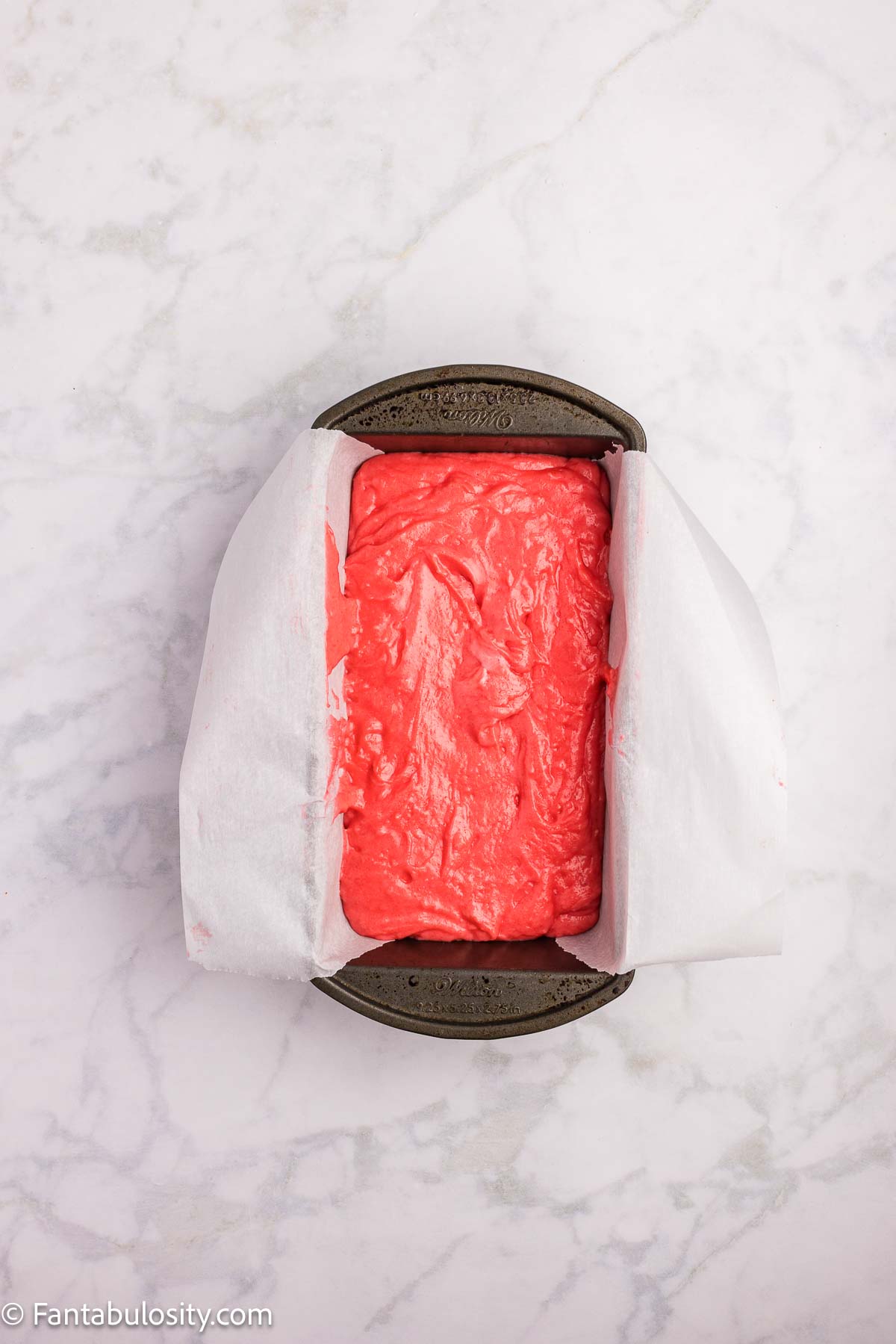 Strawberry bread batter in loaf pan.