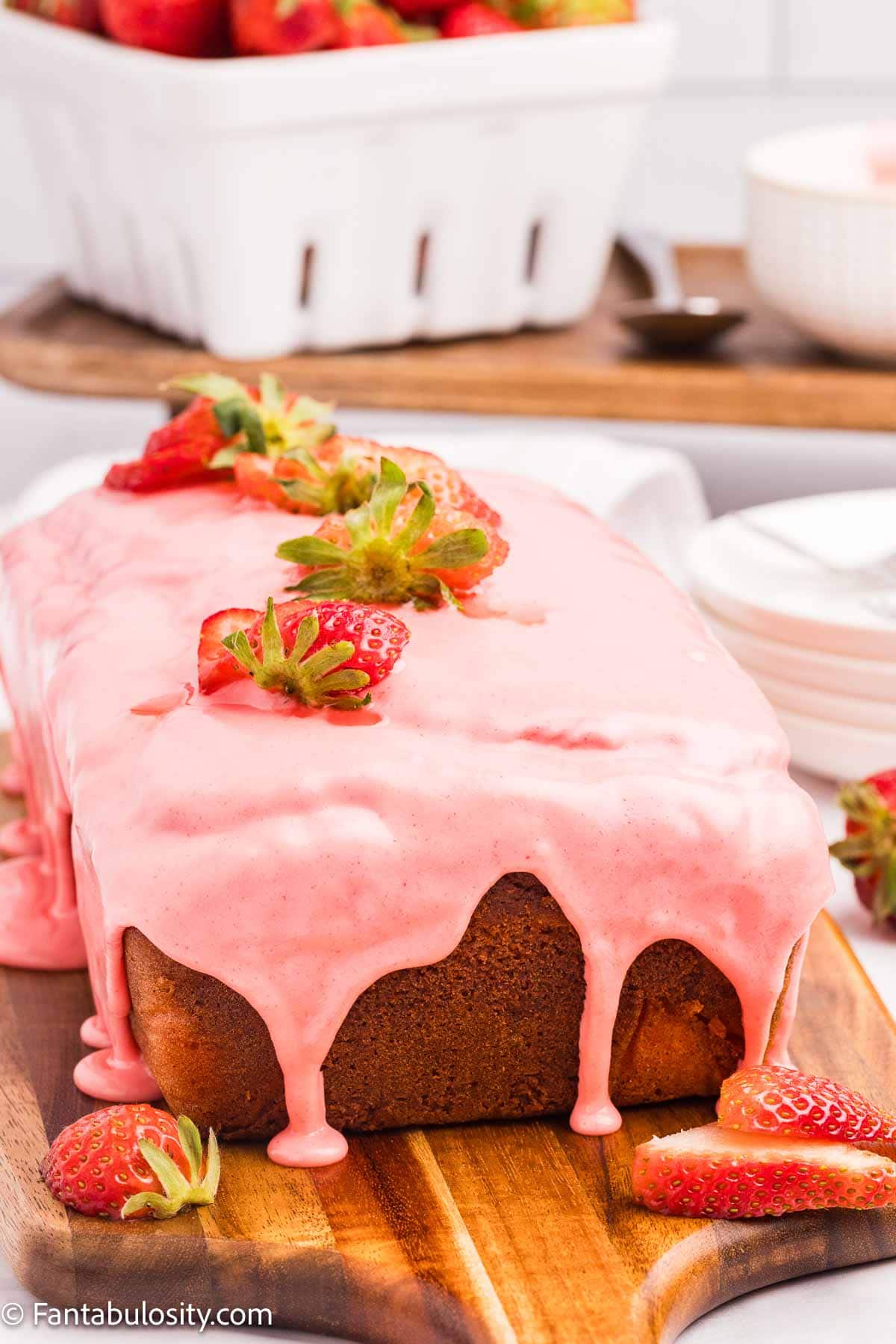 Strawberry icing poured on top of strawberry bread.