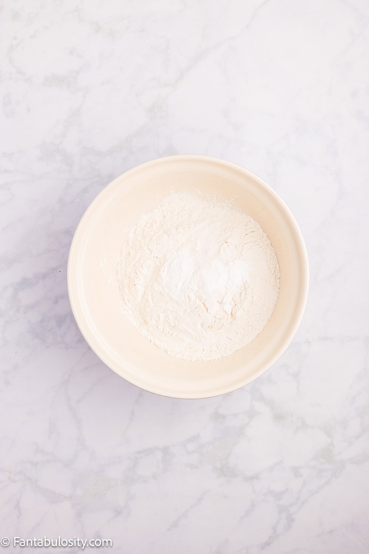 Dry ingredients mixed together in mixing bowl for strawberry bread.