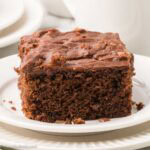 A slice of Westhaven cake on a round plate.