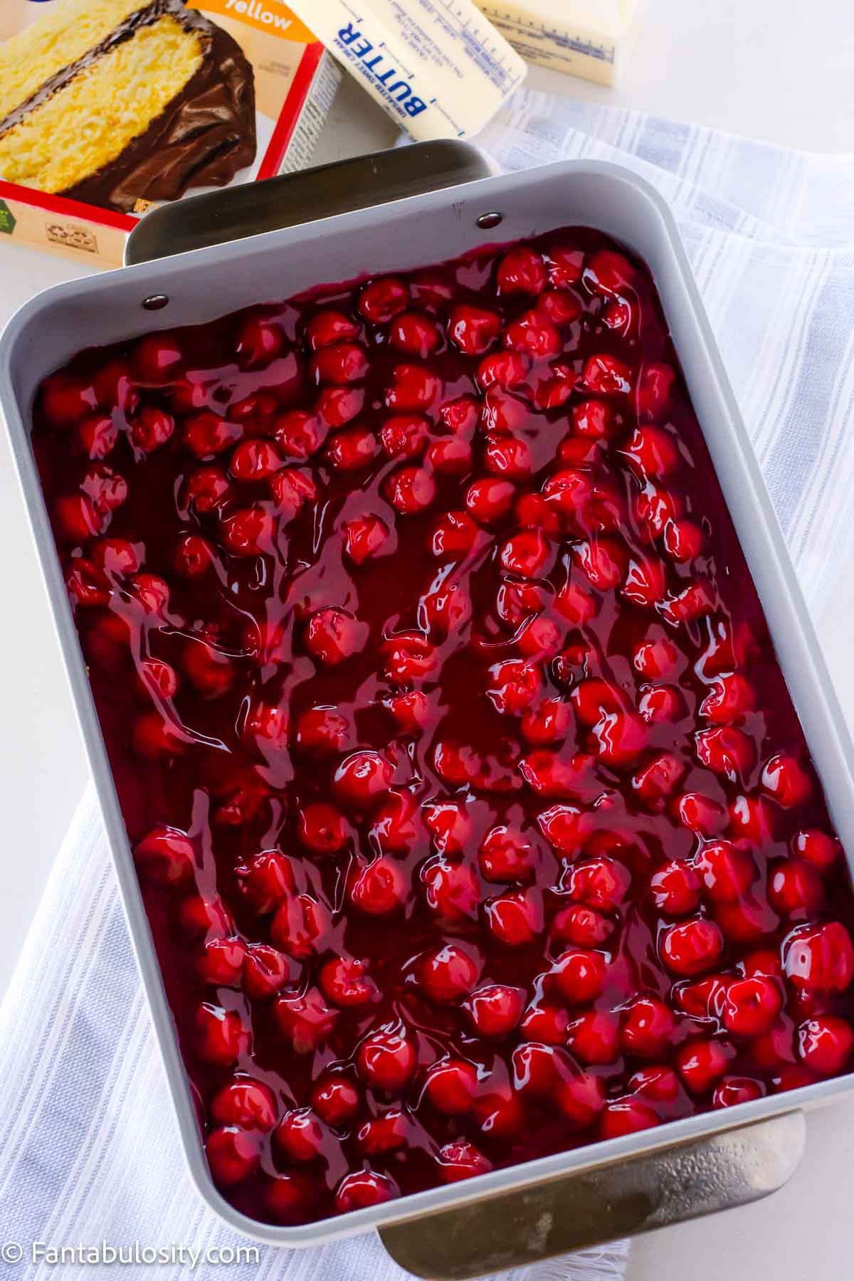 Cherry pie filling poured in to 9x13 baking dish.