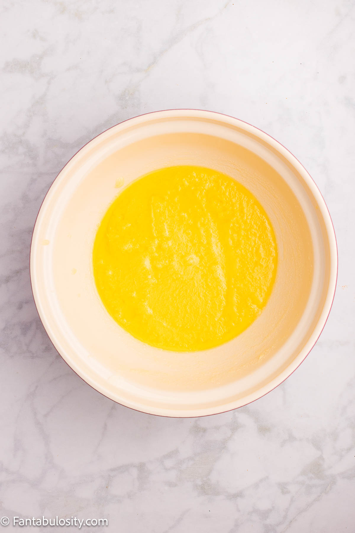 Butter and sugar in mixing bowl.