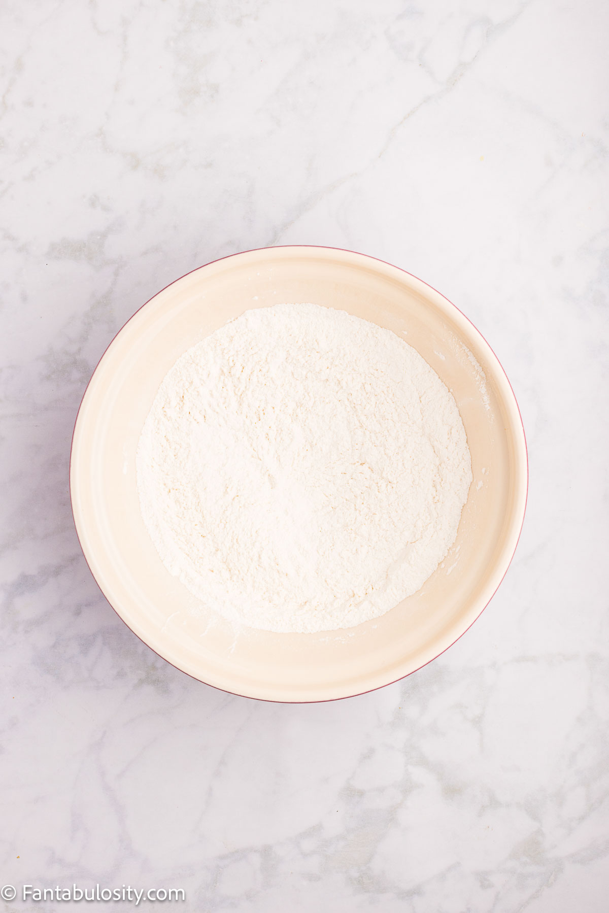 Dry ingredients for cherry bread in mixing bowl.