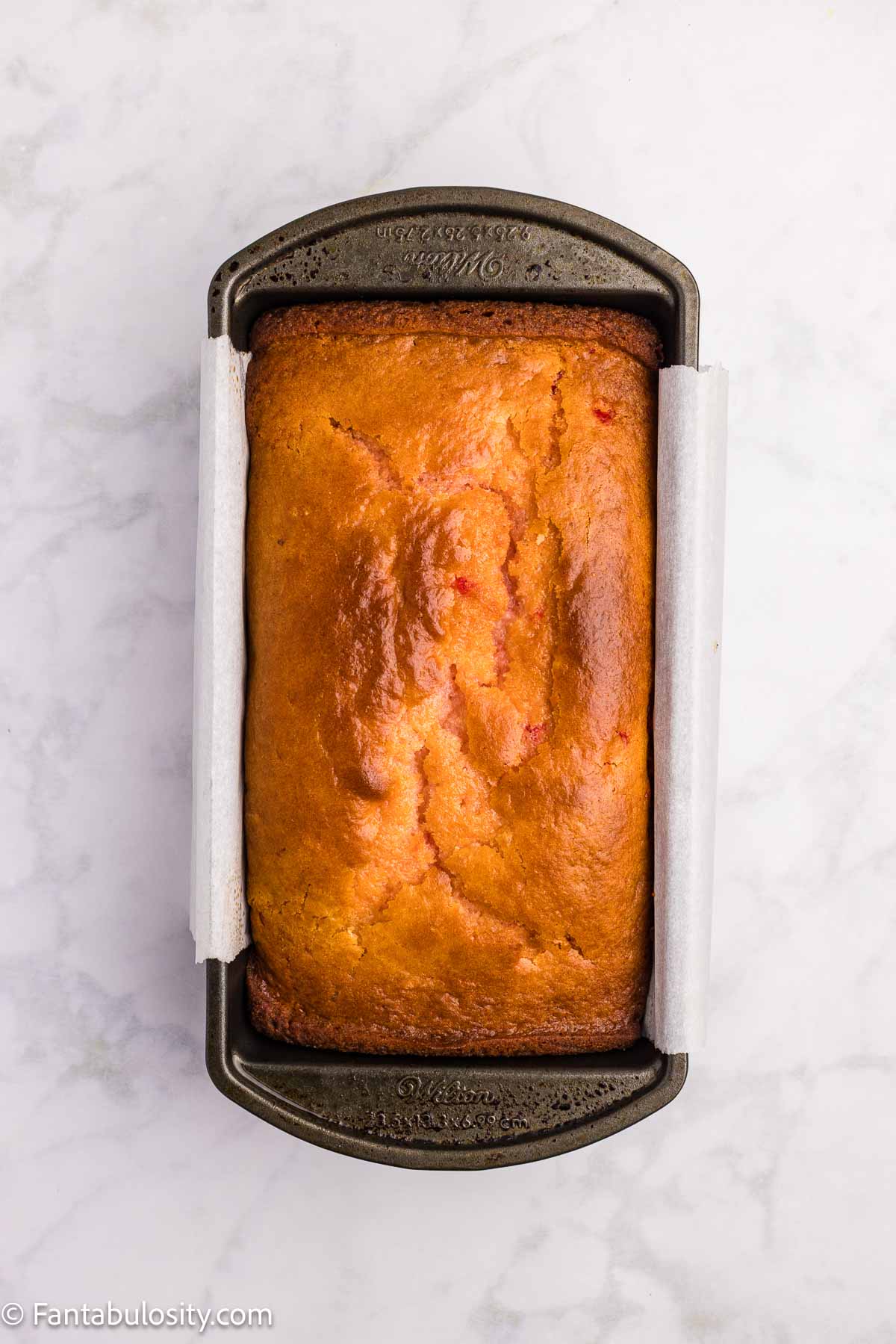 Baked cherry bread in loaf pan.
