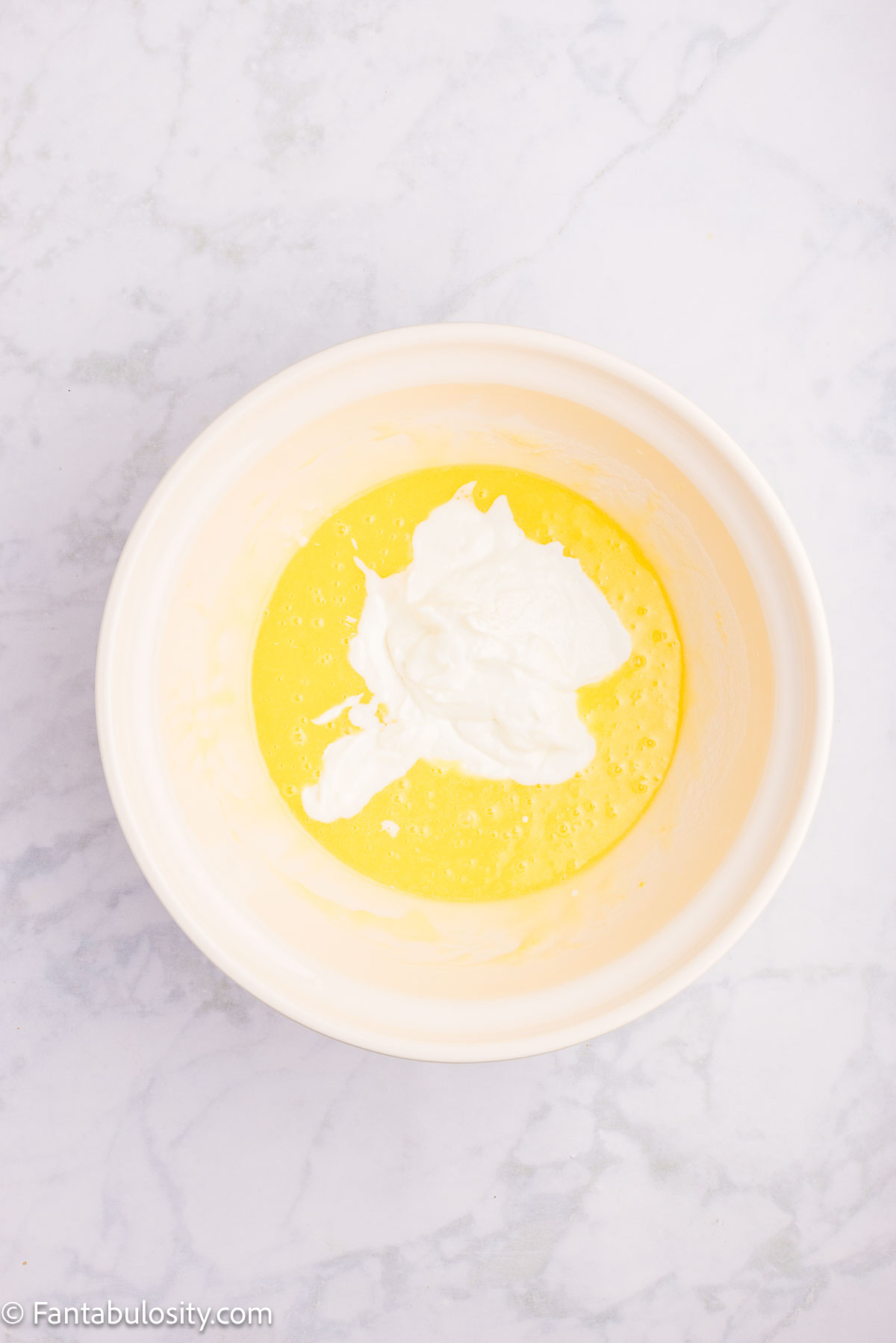 Greek yogurt, buttermilk, vanilla and almond extract added to sugar and oil mixture.