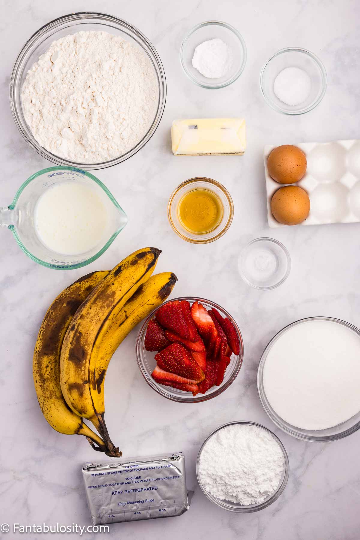 Ingredients to make strawberry banana cake sitting on counter.