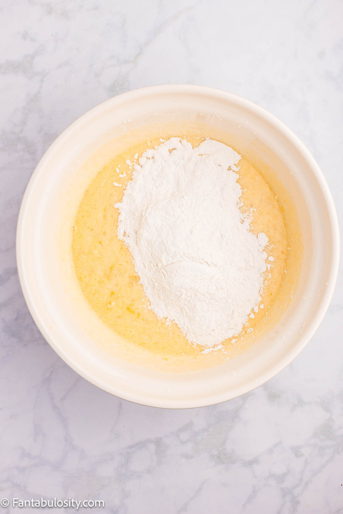 Dry ingredients added to wet ingredients for banana strawberry cake.
