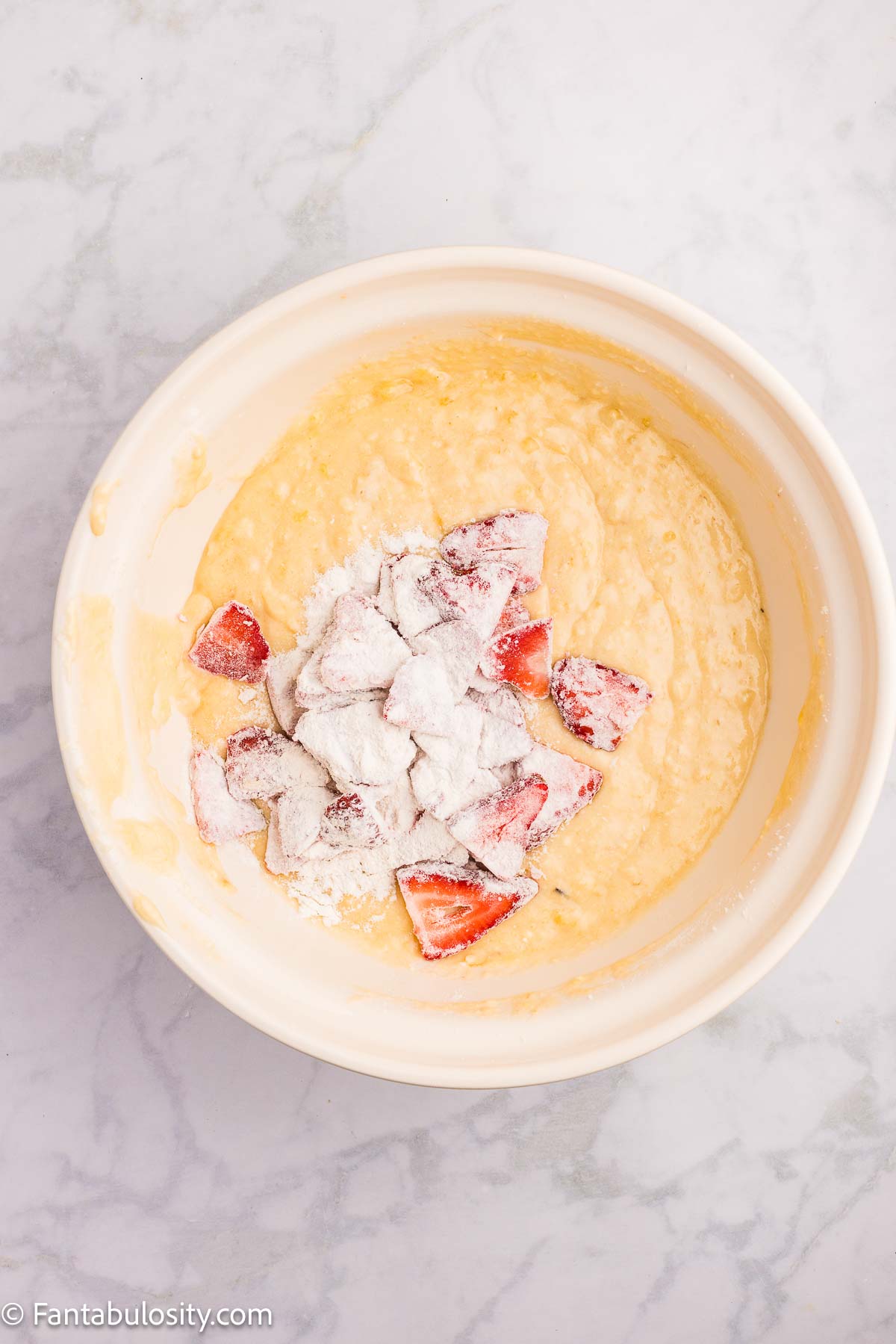 Strawberries coated in flour mixture and added to cake batter.