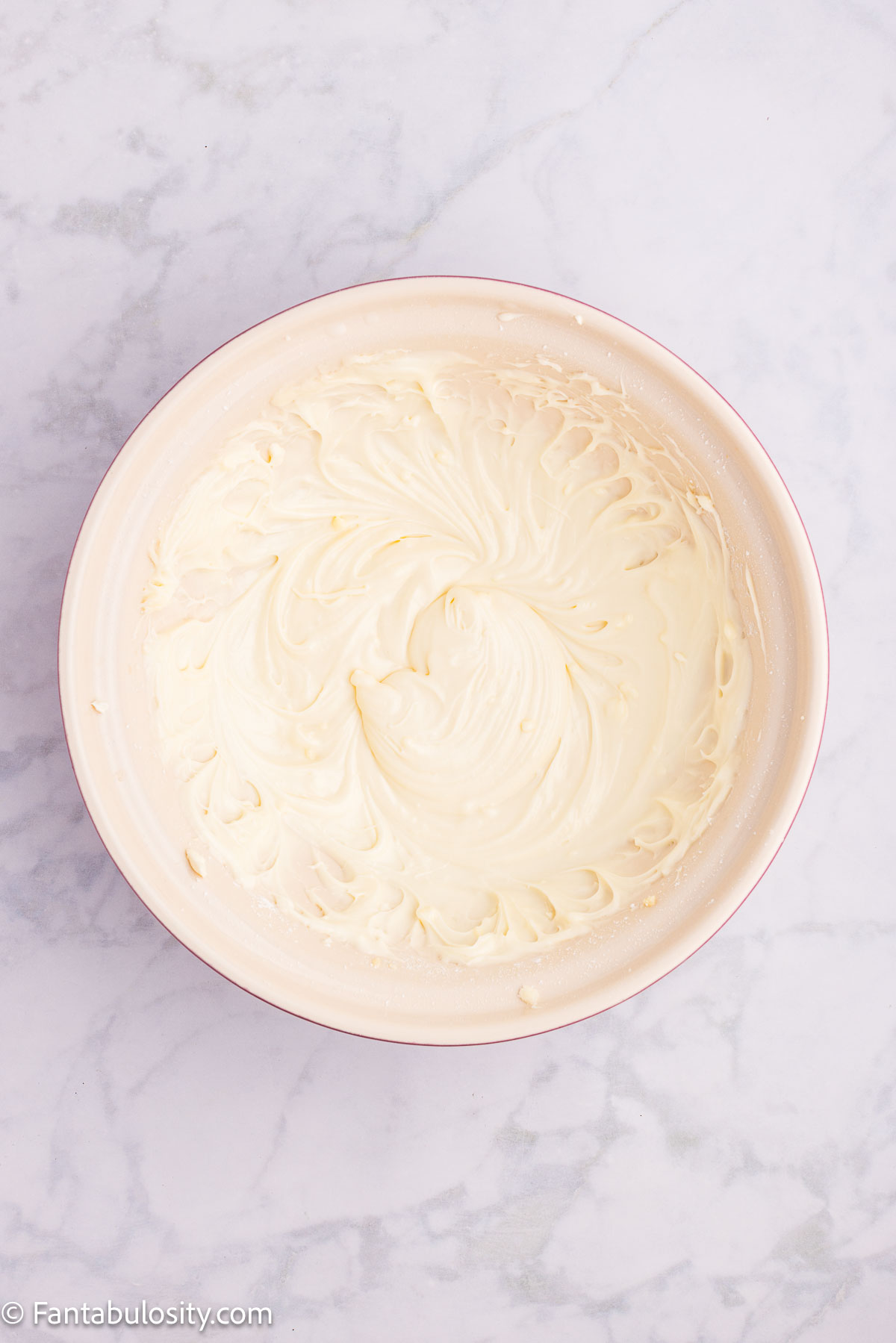 Cream cheese frosting in mixing bowl.