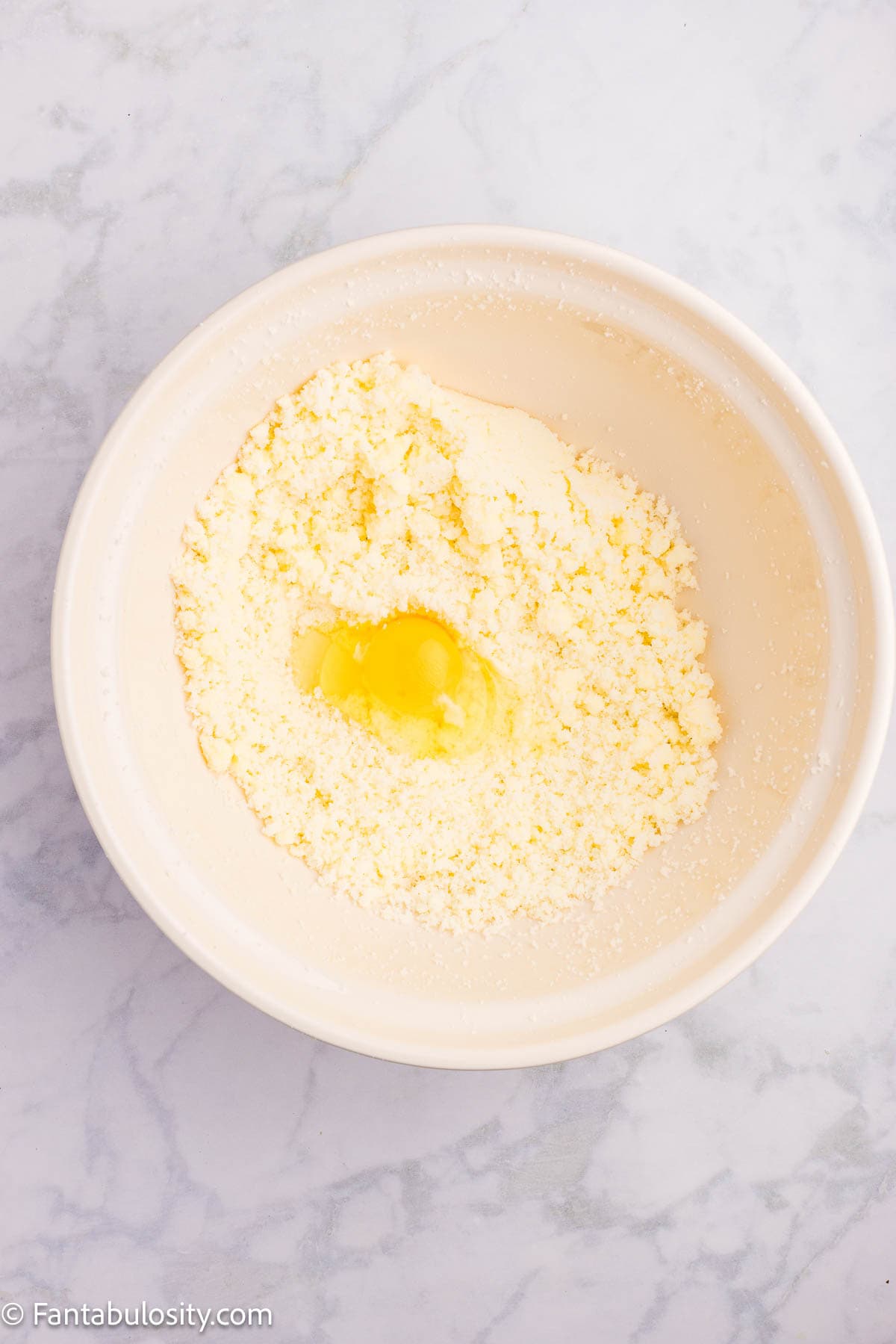 Eggs added in to mixing bowl with butter and sugar.