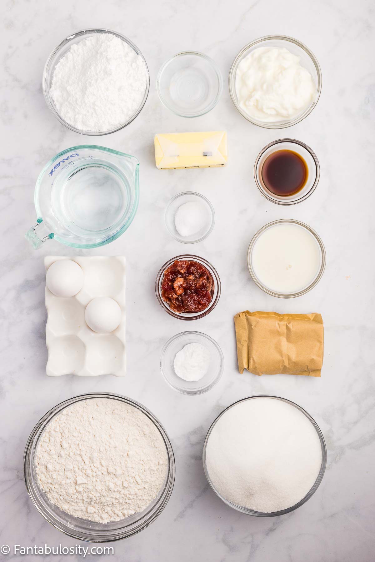 Ingredients to make strawberry Texas sheet cake on counter.
