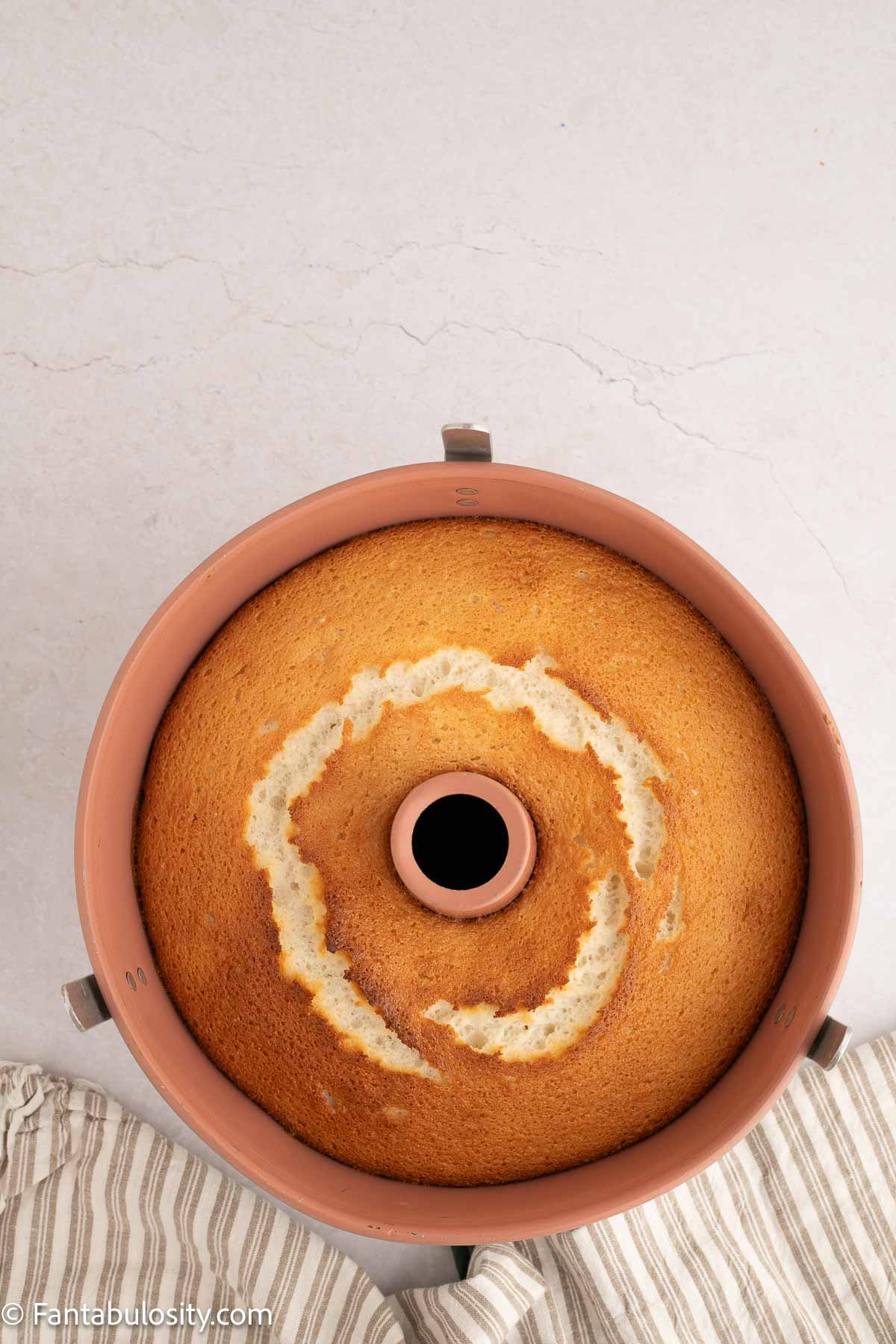 Baked angel food cake in pan.