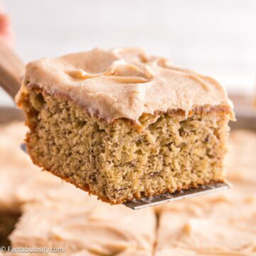 Slice of banana cake with brown butter cream cheese frosting.