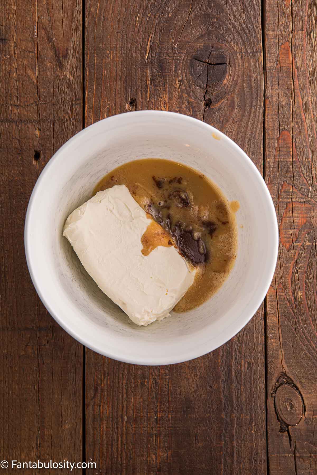 Browned butter and cream cheese in mixing bowl for browned butter frosting.